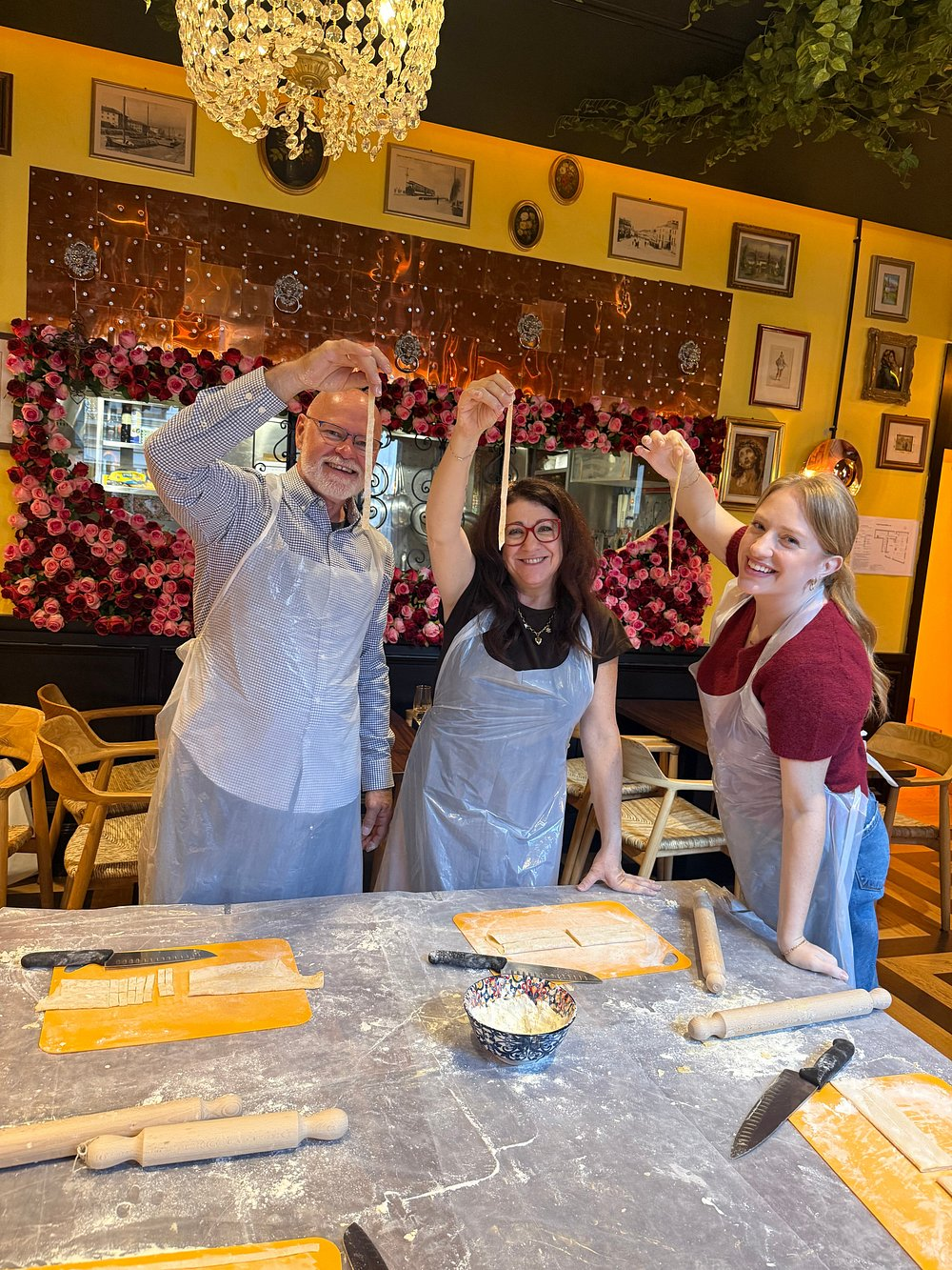 Guests making fresh pasta during a Venice cooking class